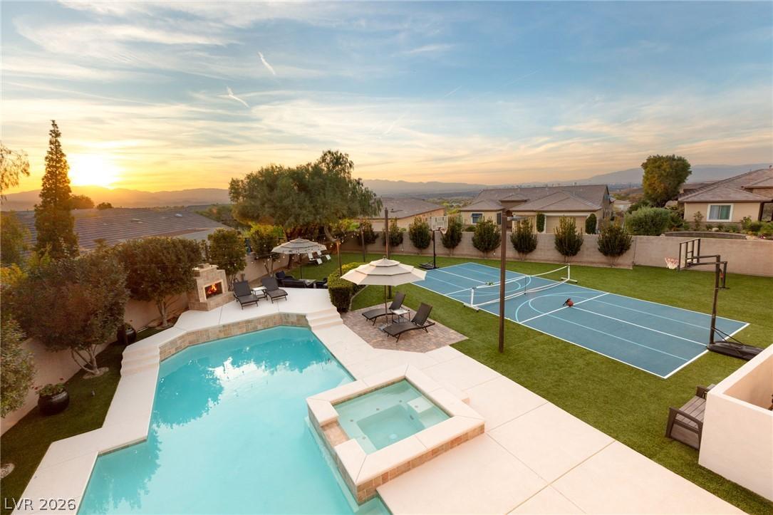 Image 1: An inviting backyard oasis offers a sparkling pool