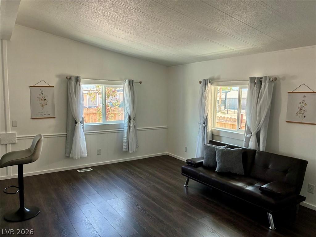 Image 3: Rich wood flooring and ample natural light define