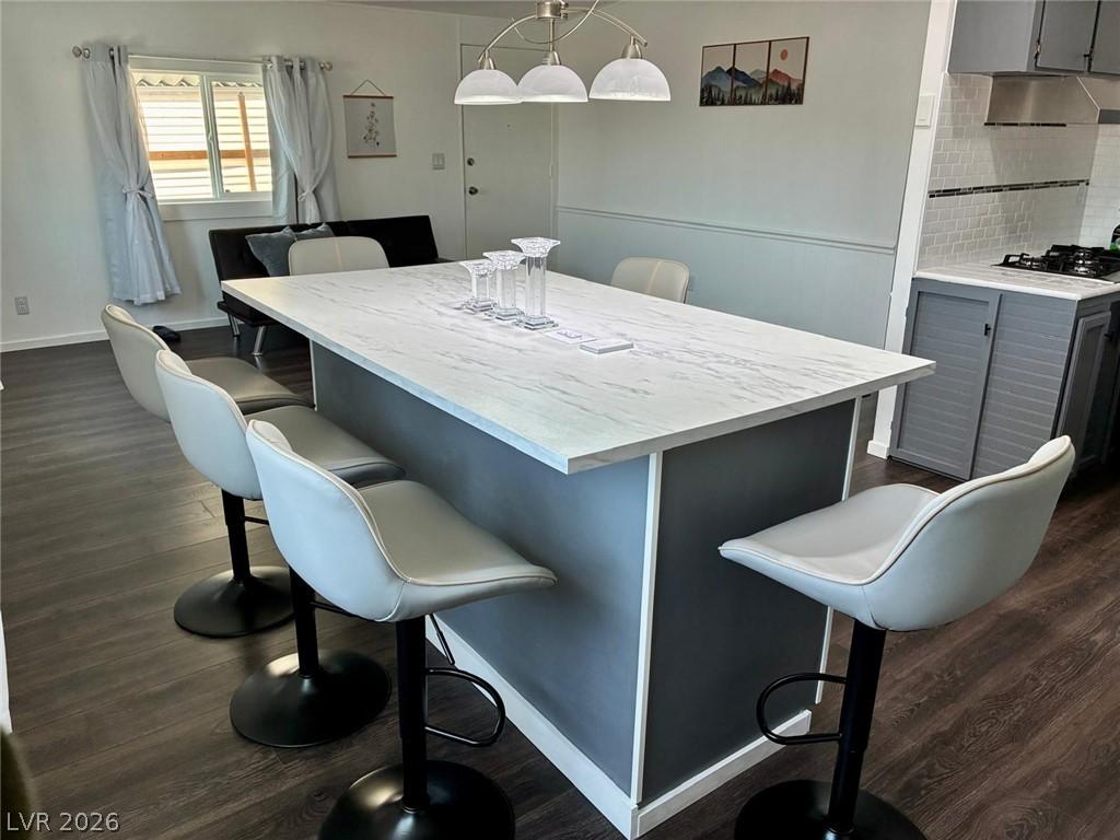 Image 4: A well-lit kitchen features a spacious island with