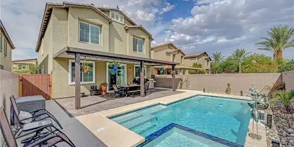 Image 2: A sparkling in-ground pool and integrated spa sit