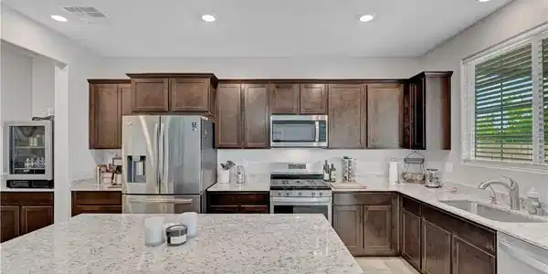 Image 4: Gleaming granite countertops pair beautifully with