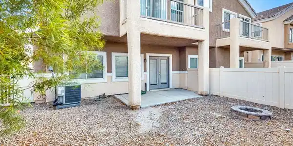 Image 4: A private fenced backyard features a covered concr