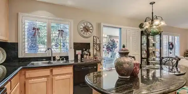 Image 4: Gleaming stone countertops and a central island gr