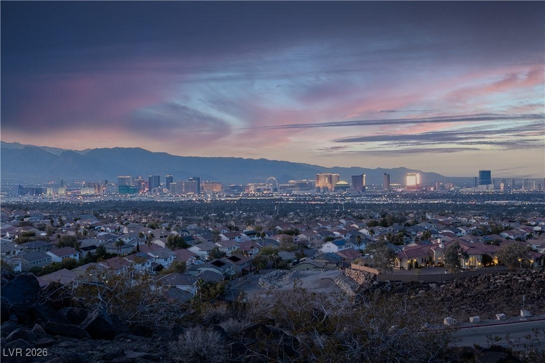 Image 1: View of city with mountains