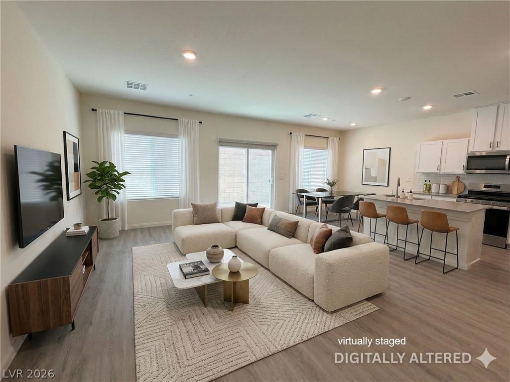 Image 3: Living area with light wood-style flooring and rec