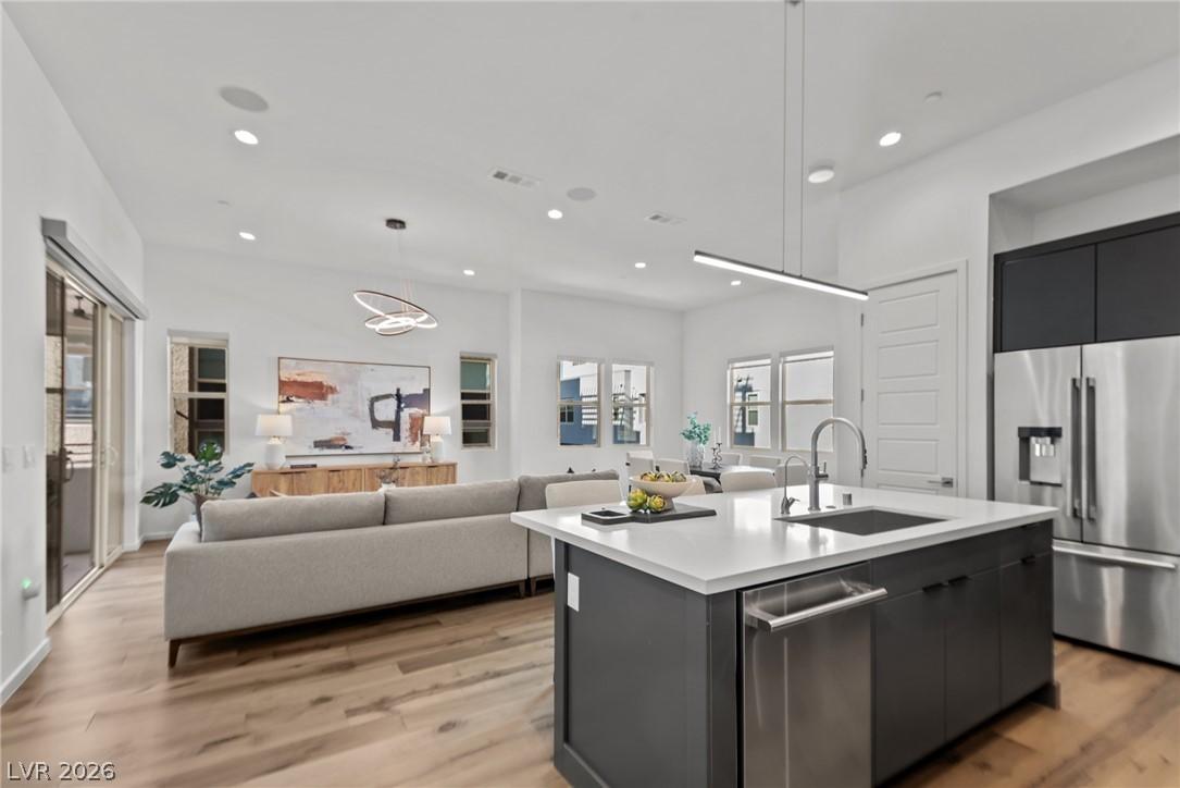 Image 1: An open floorplan seamlessly connects the kitchen
