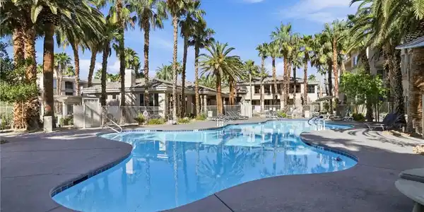 Image 2: Towering palm trees frame a sparkling resort-style