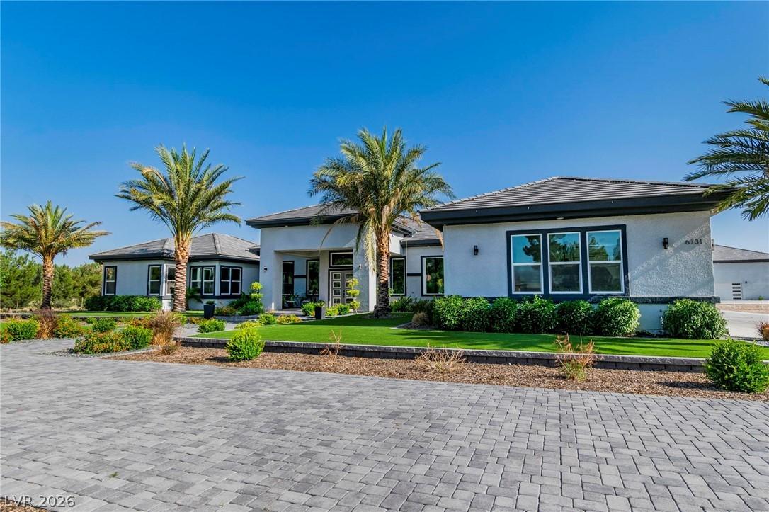 Image 3: View of front of home with stucco siding and a fro