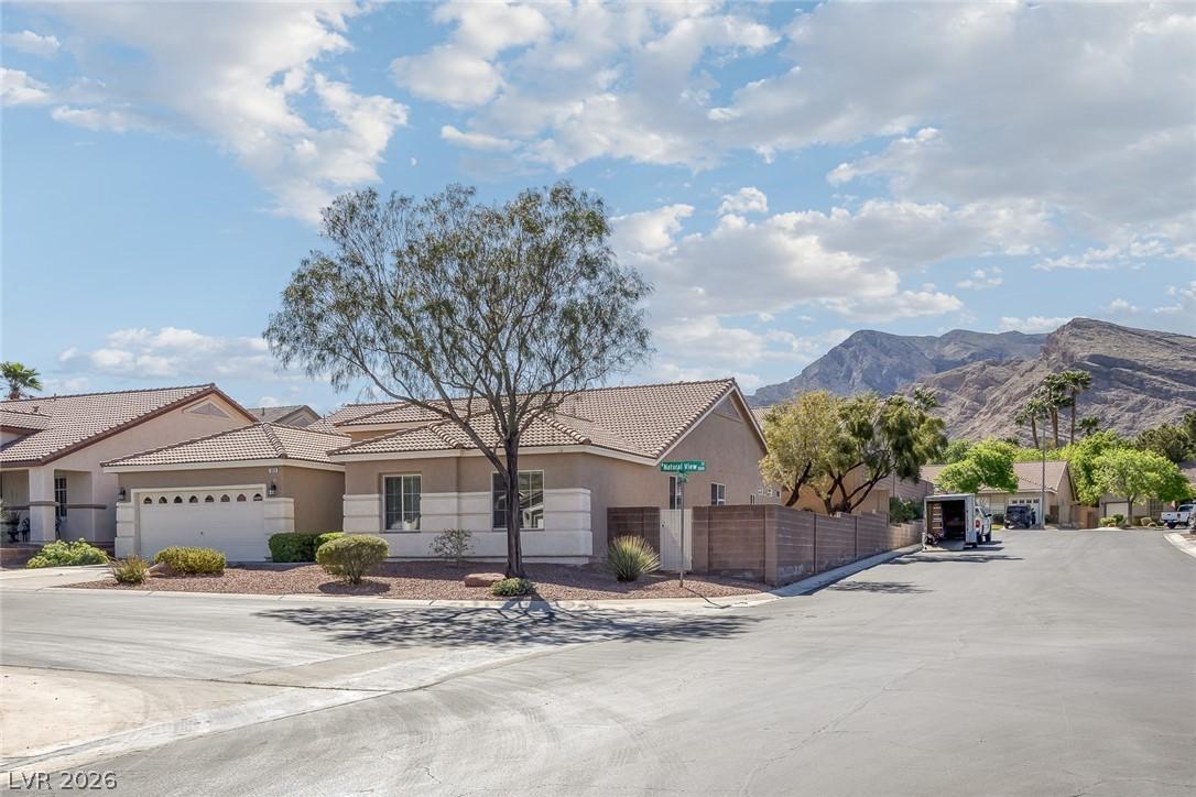 Image 1: Ranch-style home featuring stucco siding, a tiled