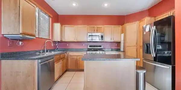 Image 2: A well-appointed kitchen showcasing light wood cab