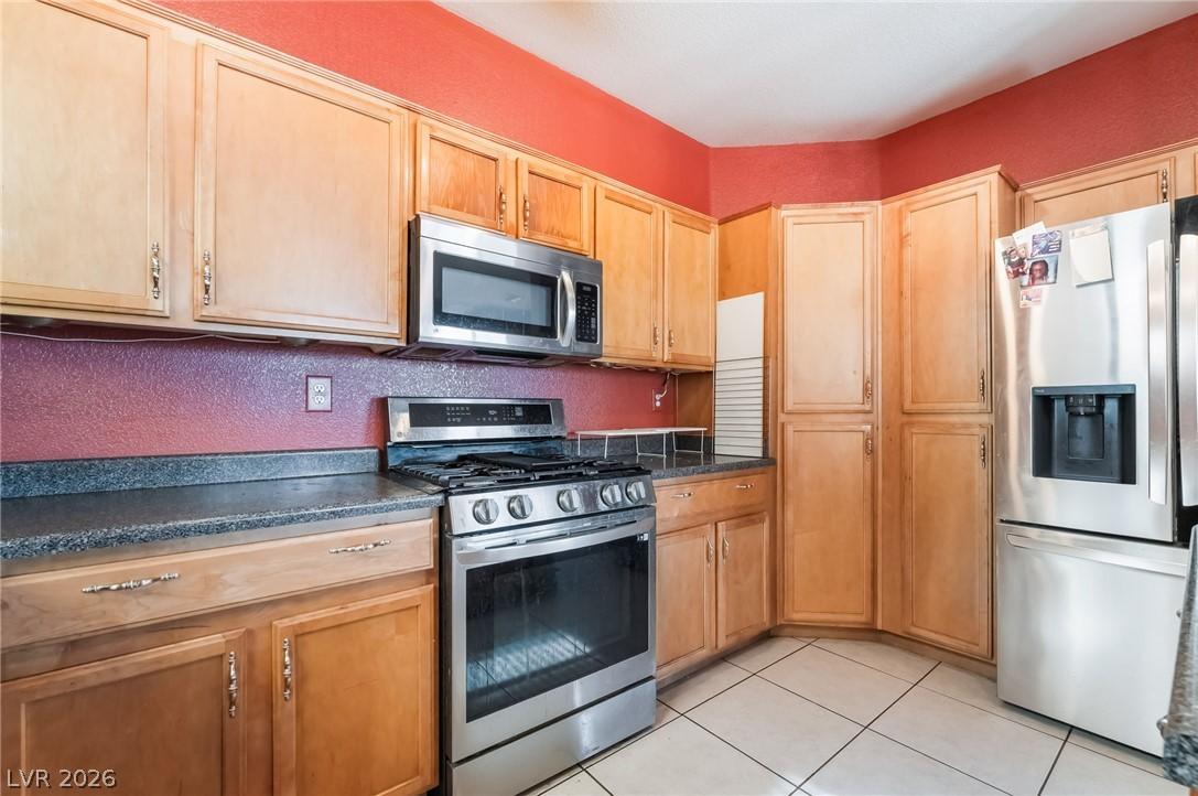 Image 4: A well-appointed kitchen features ample light wood