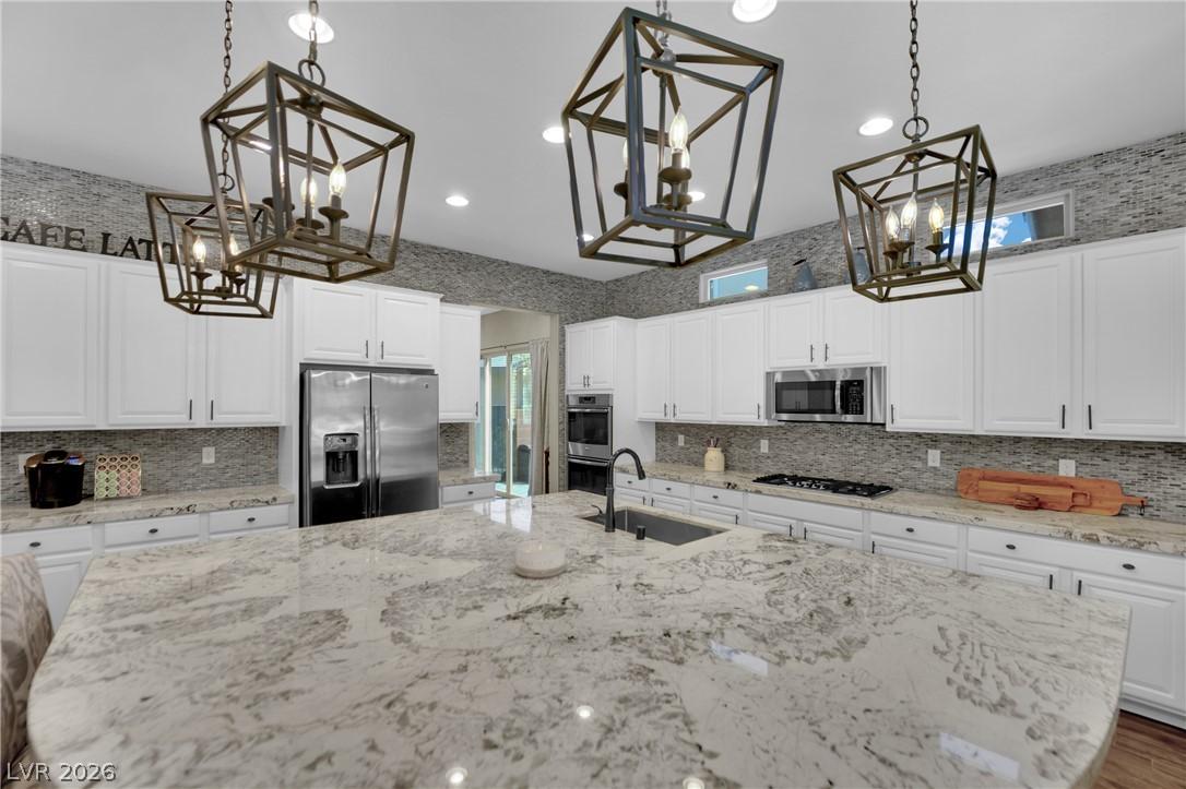 Image 3: An inviting kitchen with a spacious granite island