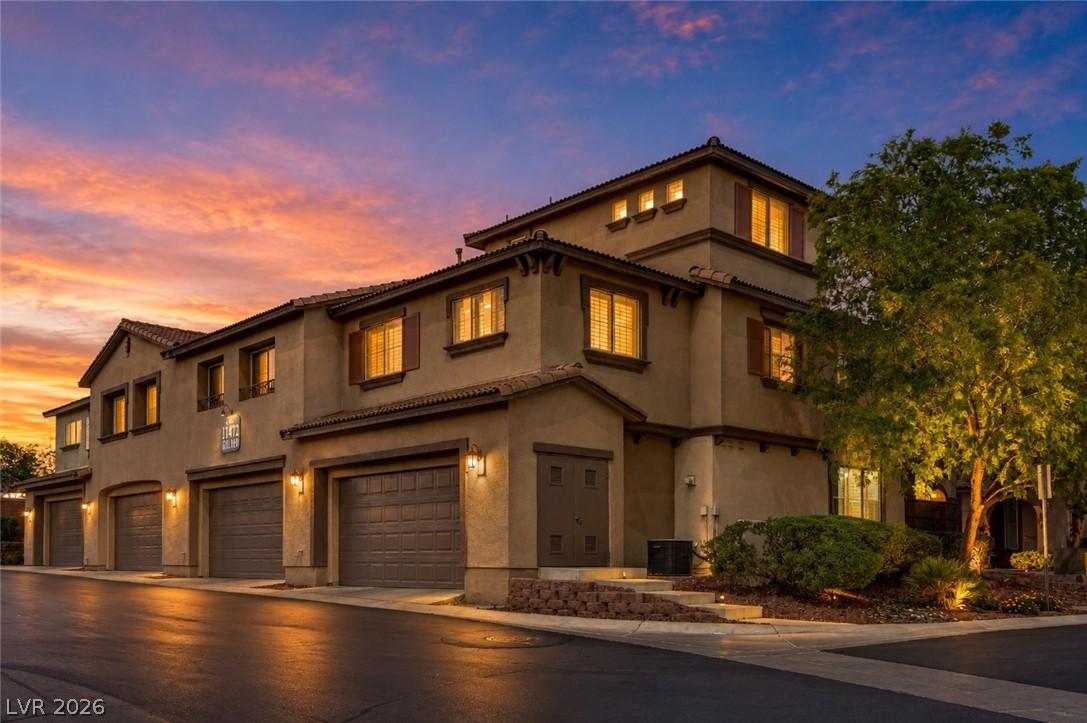 Image 2: Multi-level townhomes illuminated by evening light