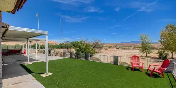 Image 2: An expansive concrete patio connects to a level la