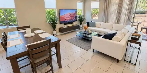 Image 4: An open-concept living and dining area displays mo