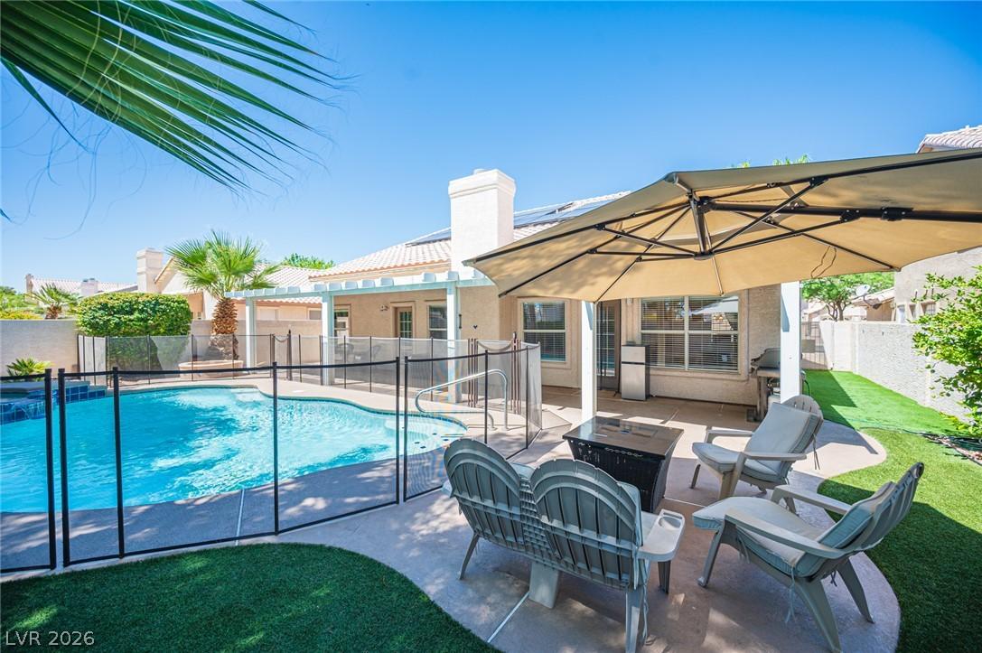 Image 4: A private backyard oasis features a shimmering poo
