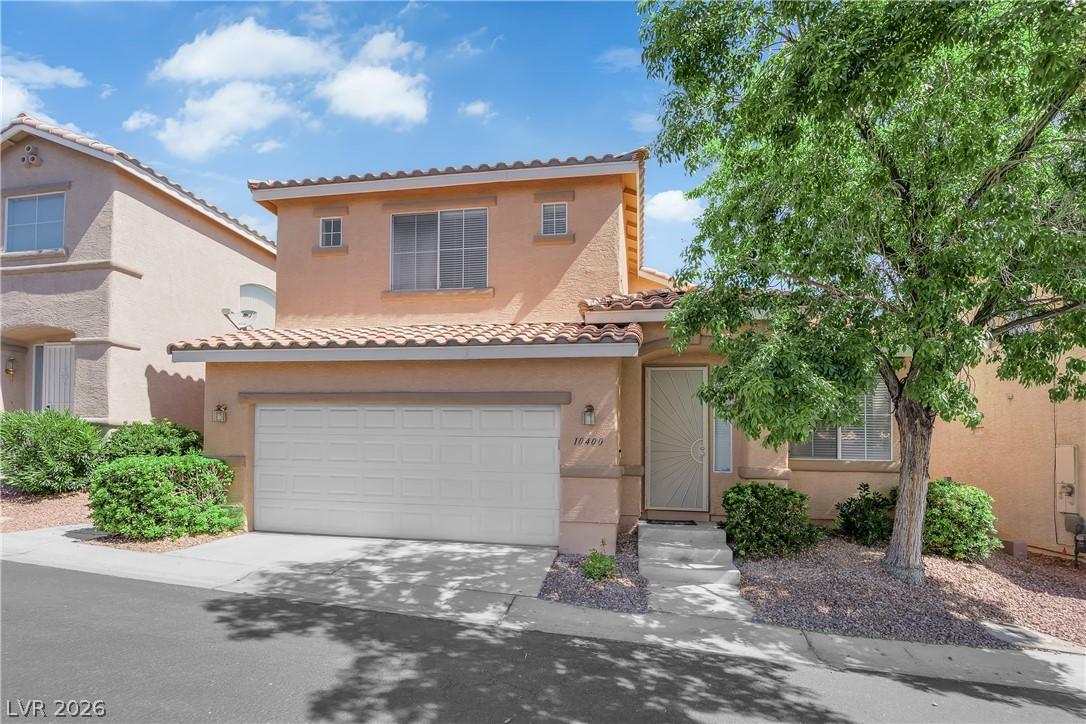 Image 3: A well-maintained stucco home with a tile roof and