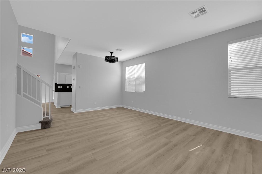 Image 4: A spacious living area with resilient vinyl plank