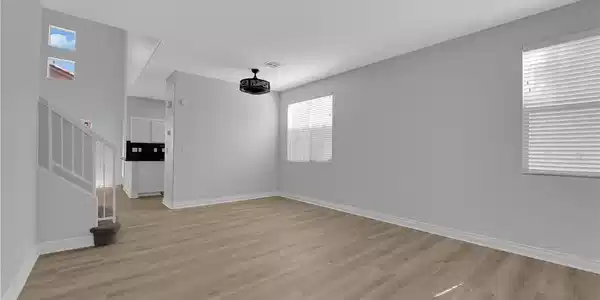Image 4: A spacious living area with resilient vinyl plank
