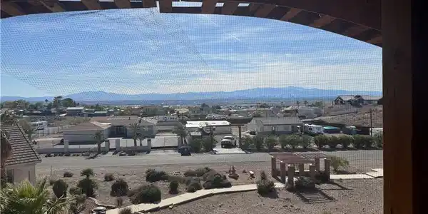 Image 2: Framed by a rustic archway, panoramic desert vista