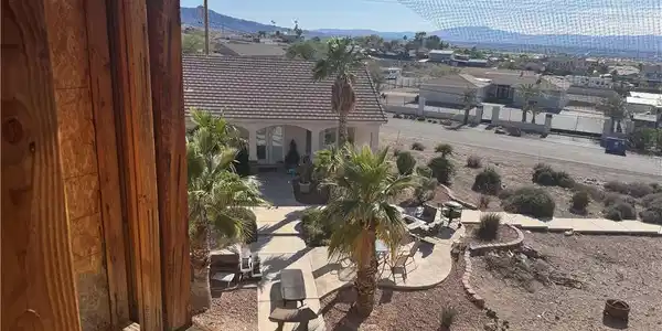 Image 3: A well-maintained outdoor patio area overlooks a n