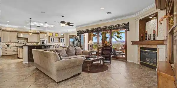 Image 3: Tile flooring and a classic fireplace anchor this