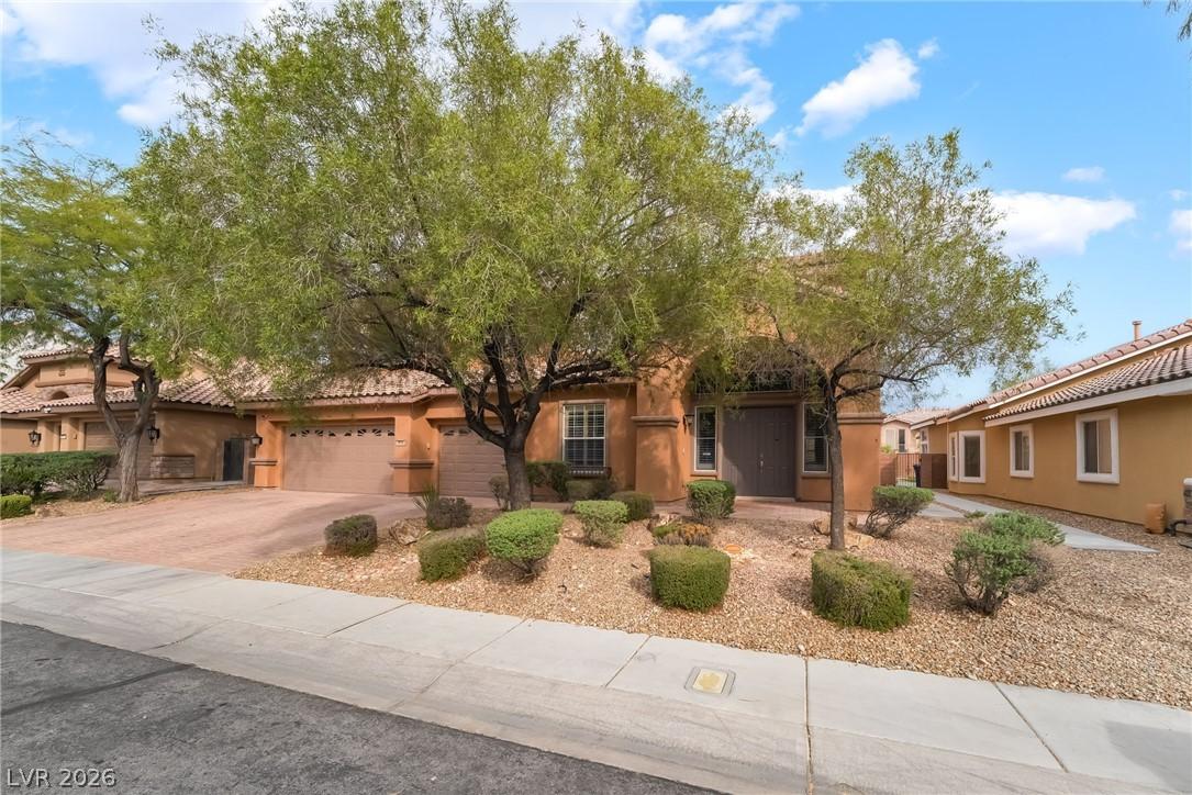 Image 4: View of front of home featuring driveway, stucco s