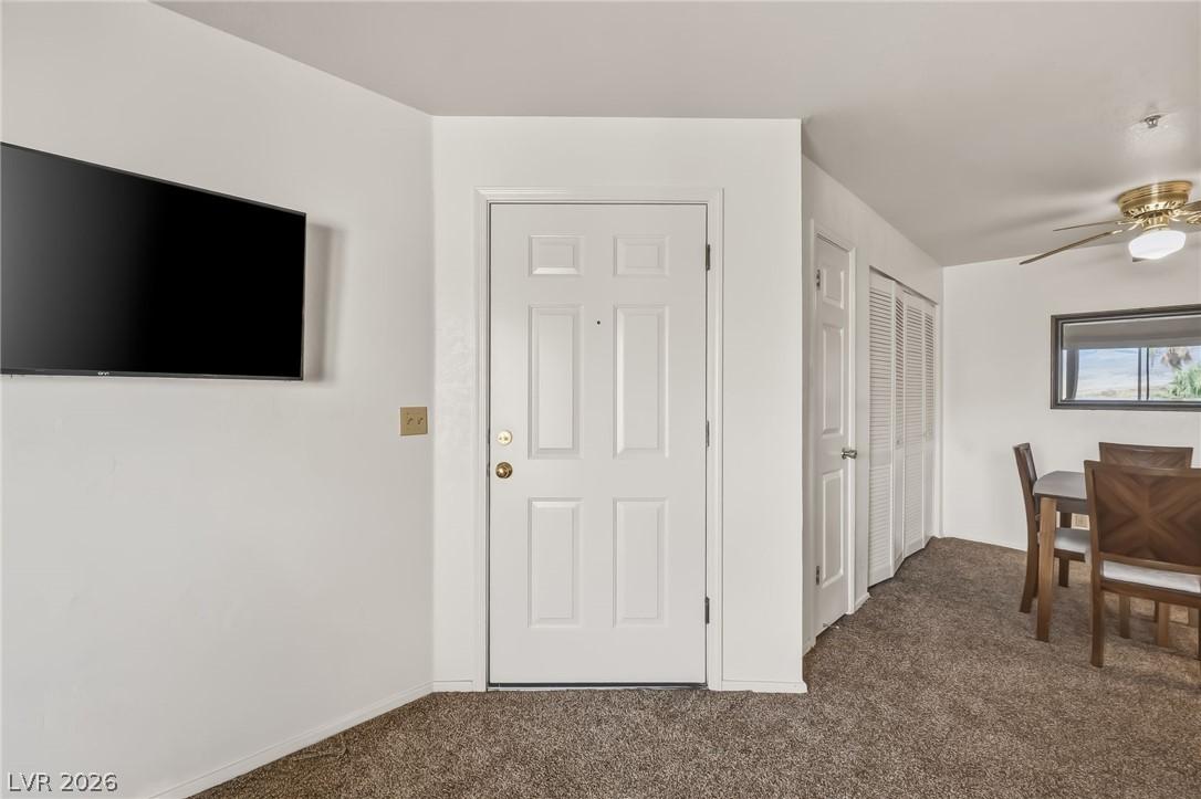 Image 2: A well-kept living space features plush carpet and