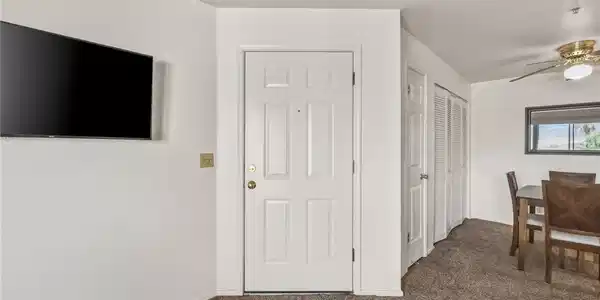 Image 2: A well-kept living space features plush carpet and