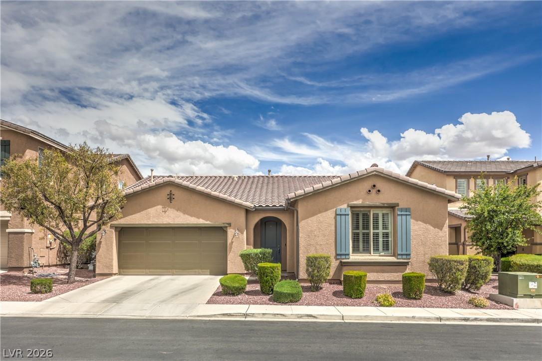 Image 1: A desert-friendly front yard frames this inviting