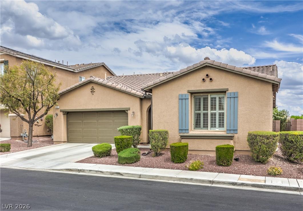 Image 2: A welcoming front exterior features a driveway and