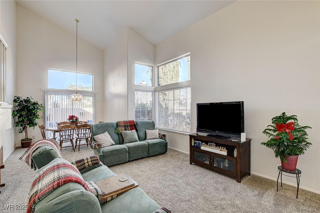 Image 4: Carpeted living room featuring high vaulted ceilin