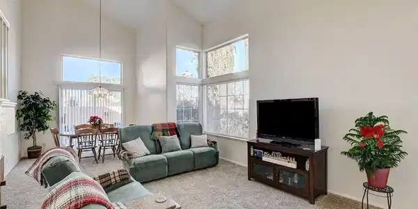 Image 4: Carpeted living room featuring high vaulted ceilin
