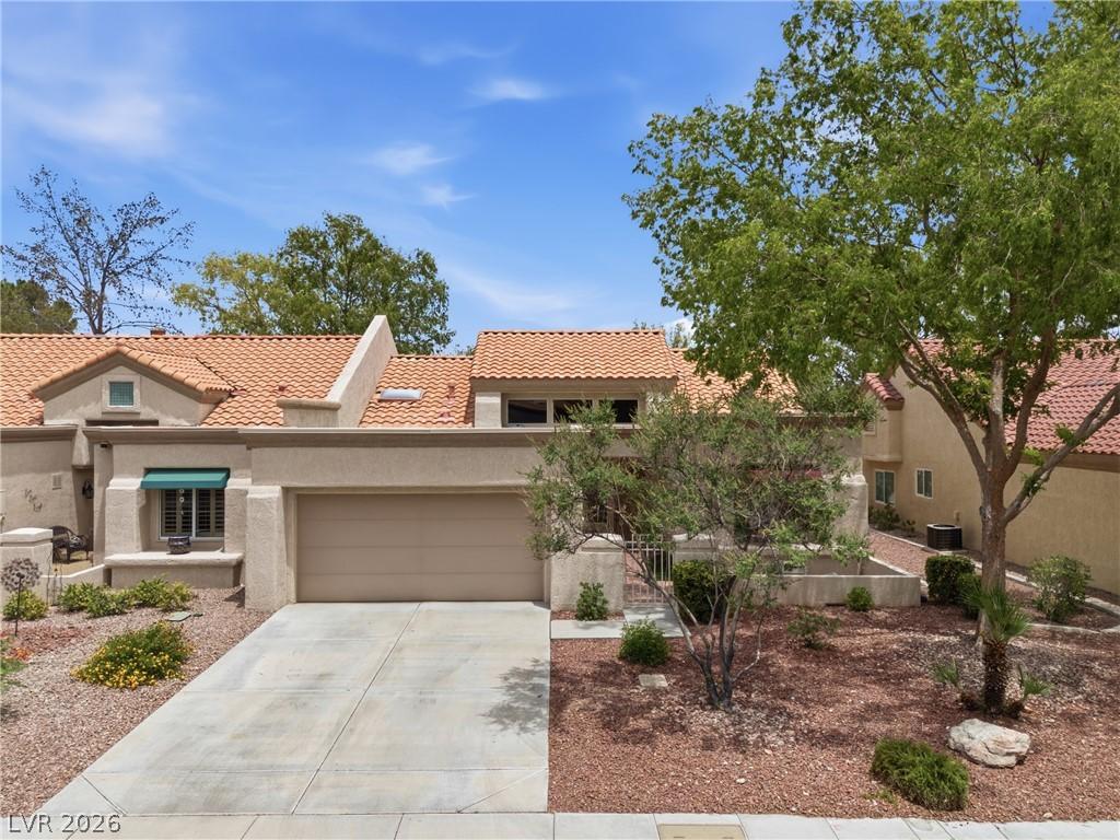 Image 4: A well-maintained stucco exterior and concrete dri