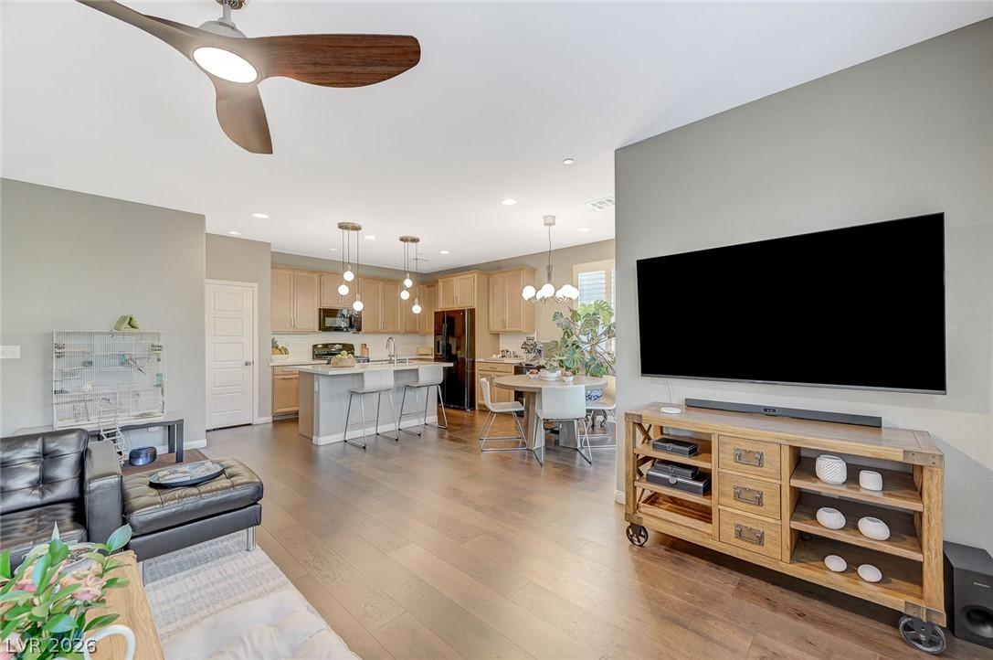 Image 3: An open concept living area features gleaming hard