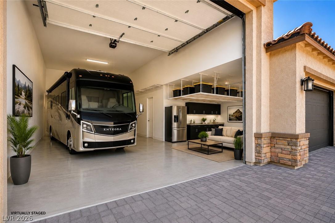 Image 2: A spacious RV garage features an additional living