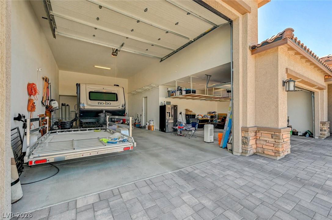Image 3: A RV garage featuring high ceilings, ample storage