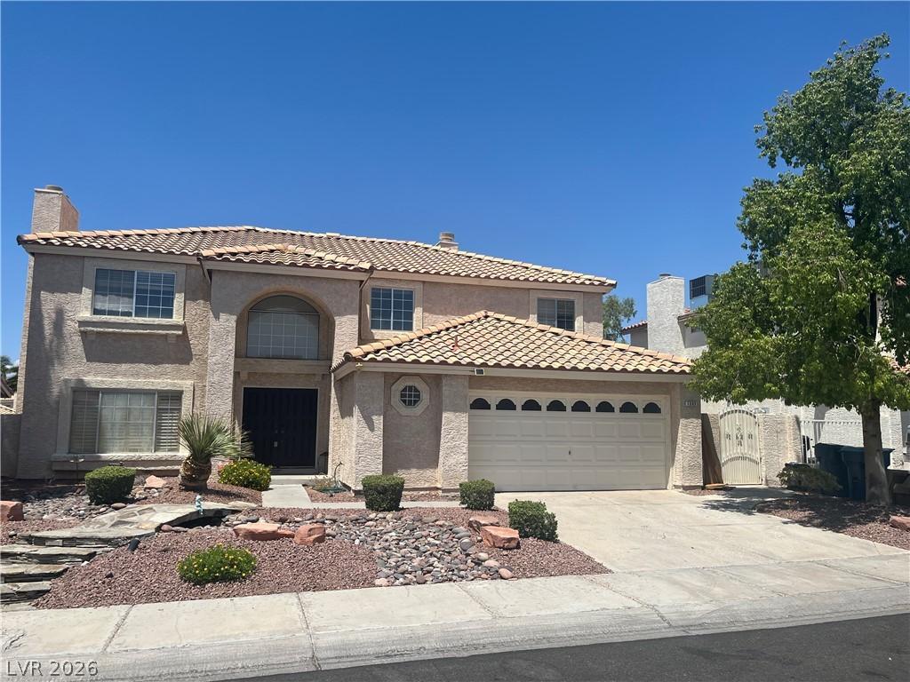 Image 4: A classic two-story residence with a tan stucco fa