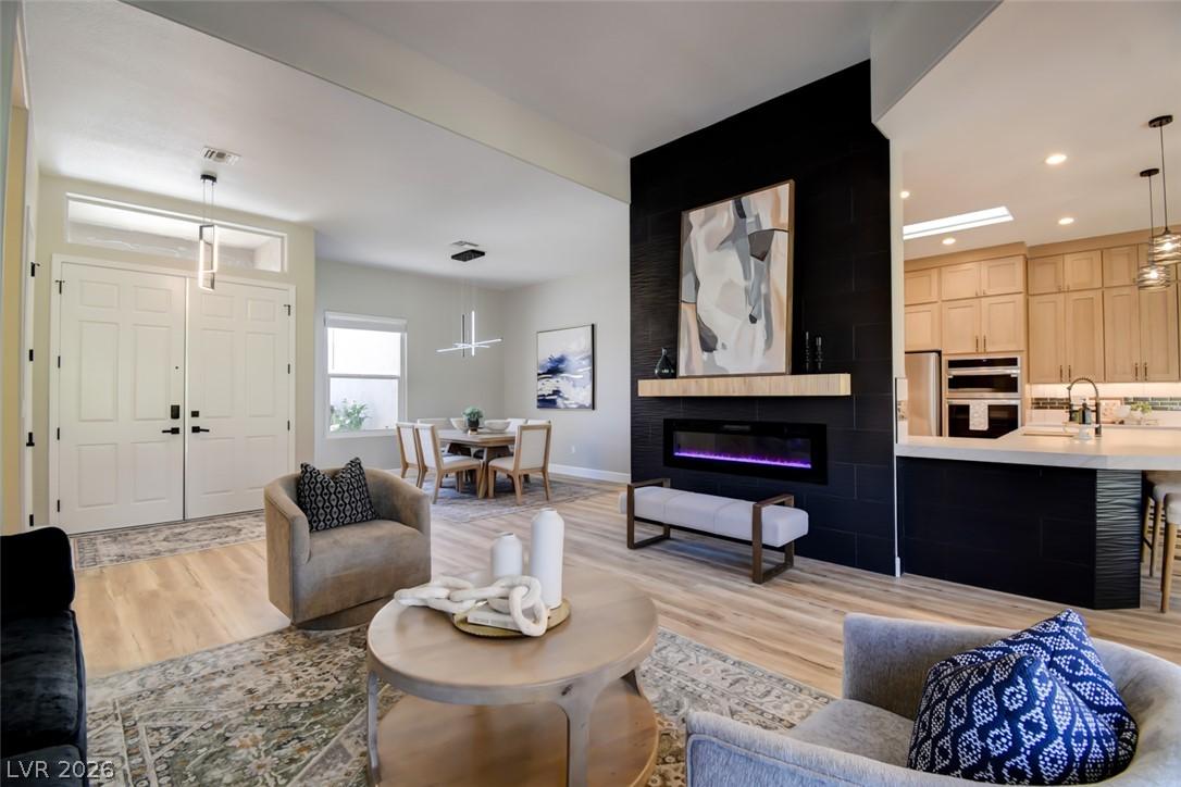 Image 2: An inviting open-concept living area boasts a slee