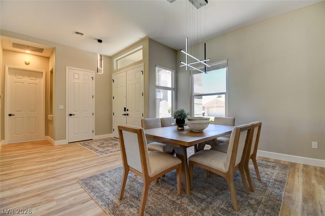 Image 4: Natural light illuminates this spacious dining roo