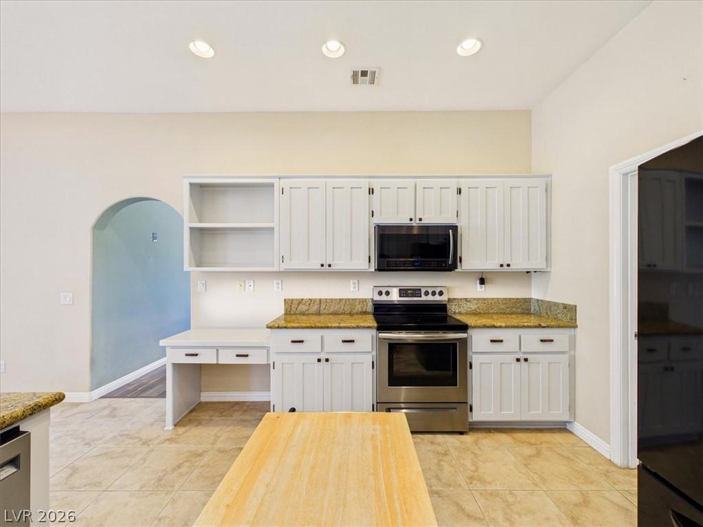 Image 2: A well-appointed kitchen features ample cabinetry,