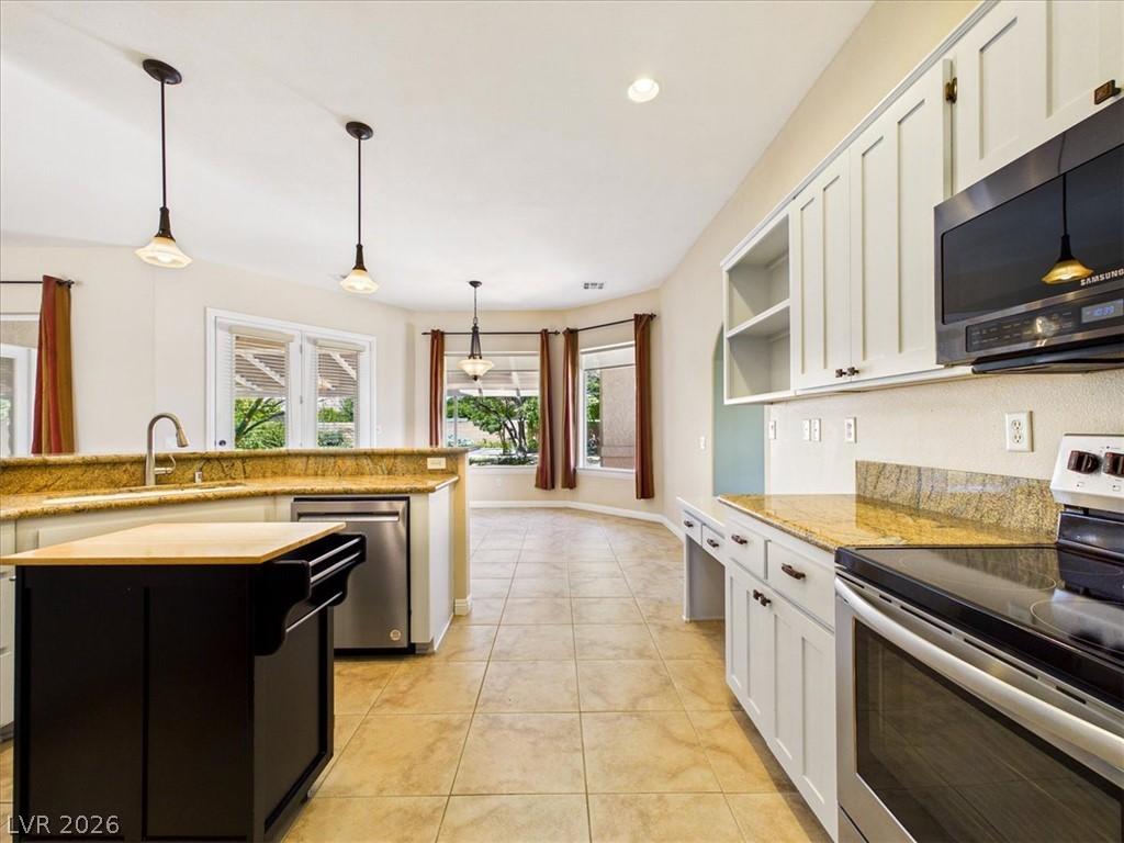 Image 4: A well-appointed kitchen showcasing elegant pendan