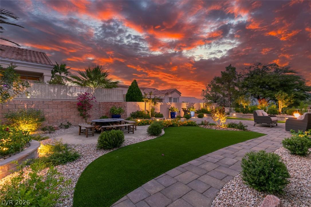 Image 2: An inviting backyard oasis offers both dining and