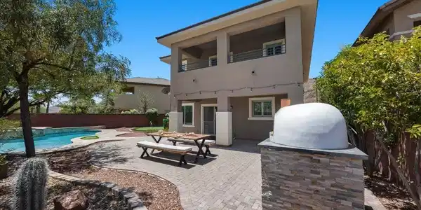 Image 3: An inviting stone patio offers space for outdoor d