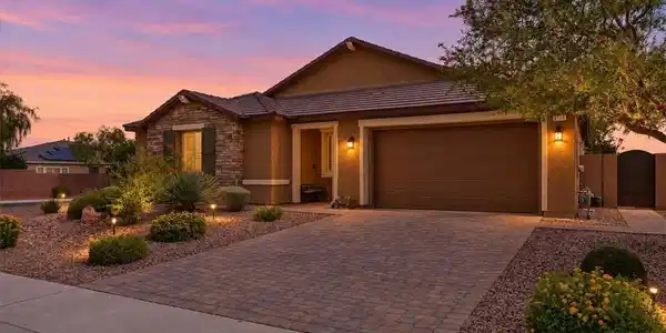 Image 2: Stone accents and a paved driveway complement this