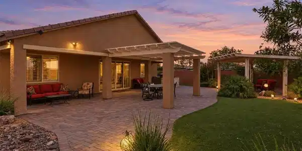 Image 3: A spacious paved patio and covered pergola overloo