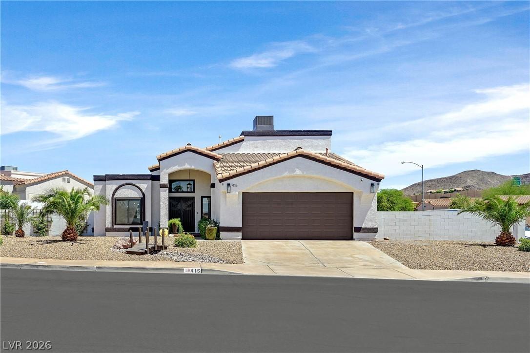 Image 1: A desert-inspired exterior with stucco finish and