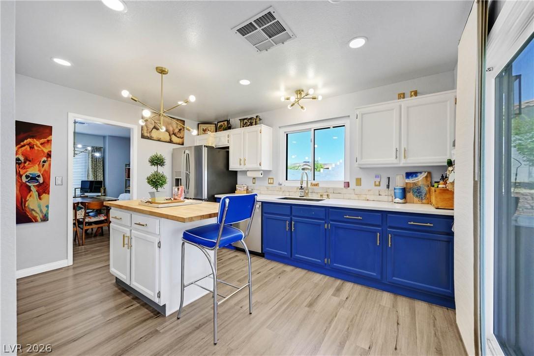 Image 4: A well-lit kitchen with sleek wooden flooring and