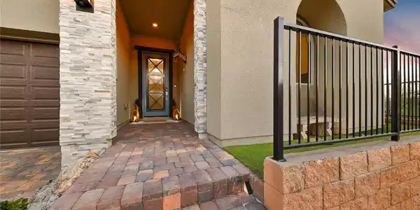 Image 3: An inviting stone-accented entryway features a war