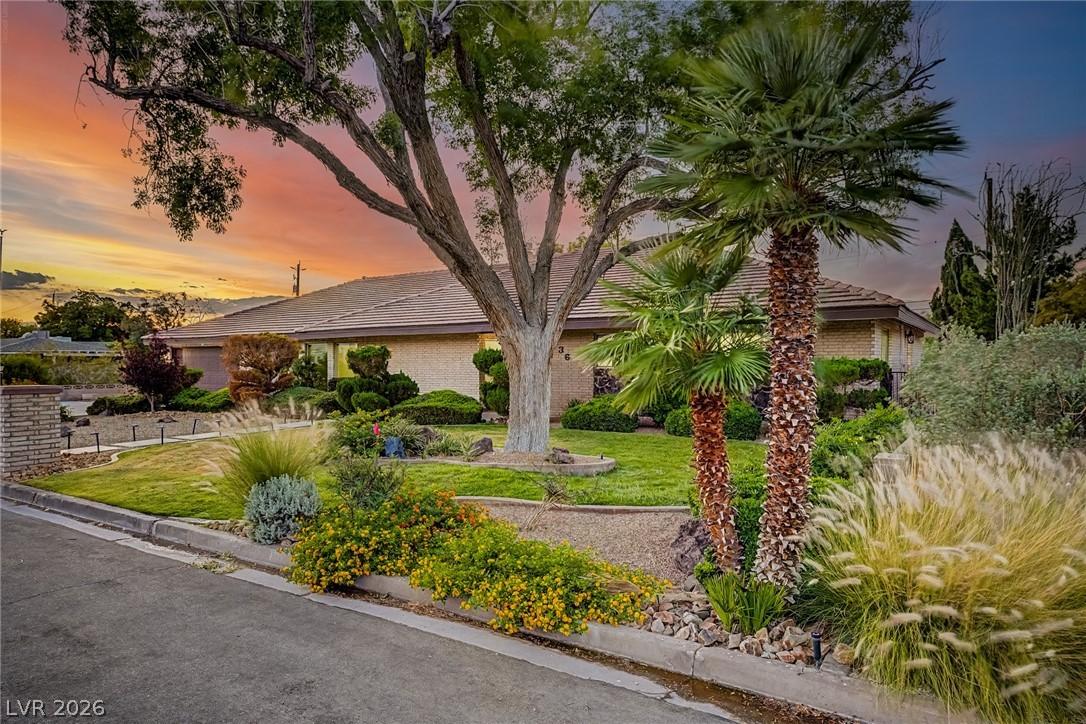 Image 3: Manicured landscaping and mature trees frame this